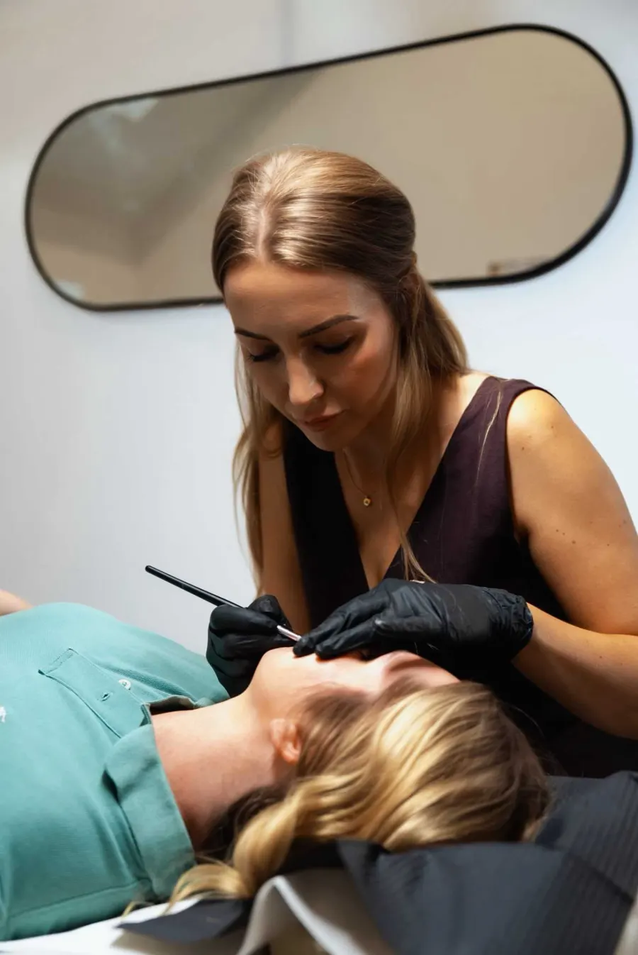 Sadie mapping brows during a semi-permanent make up appointment